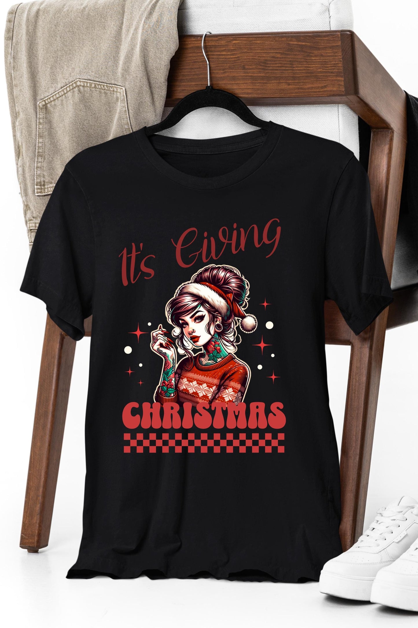 a black t - shirt with a picture of a girl wearing a santa claus hat