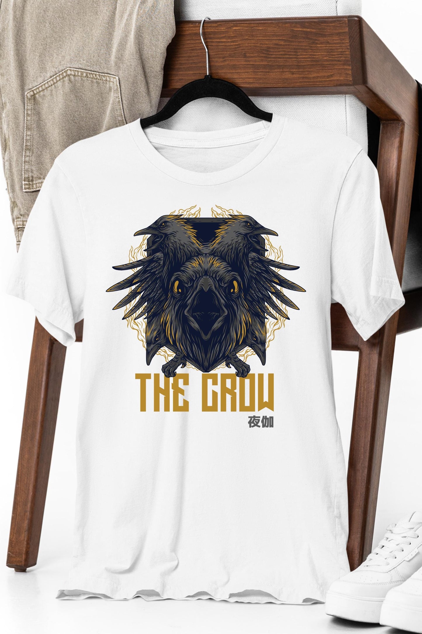 a white t - shirt with an image of a crow on it