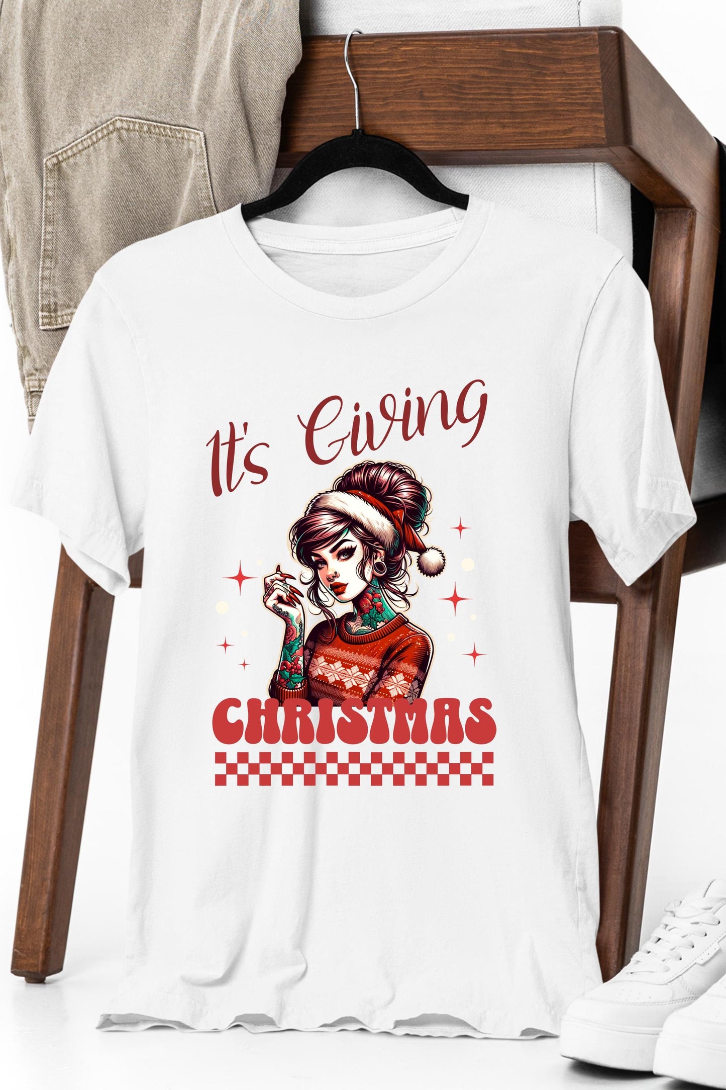 a white t - shirt that says it's giving christmas