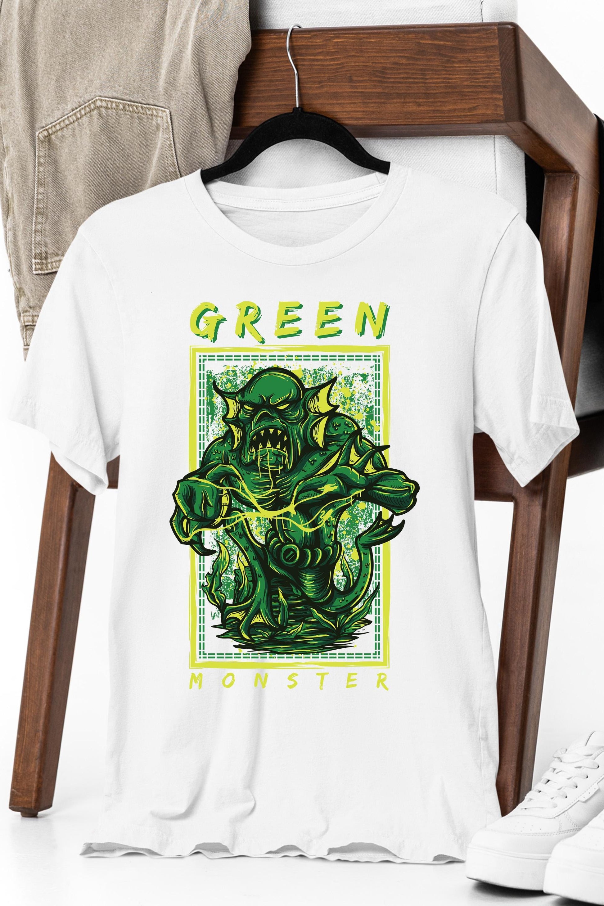 a white t - shirt with a green monster on it
