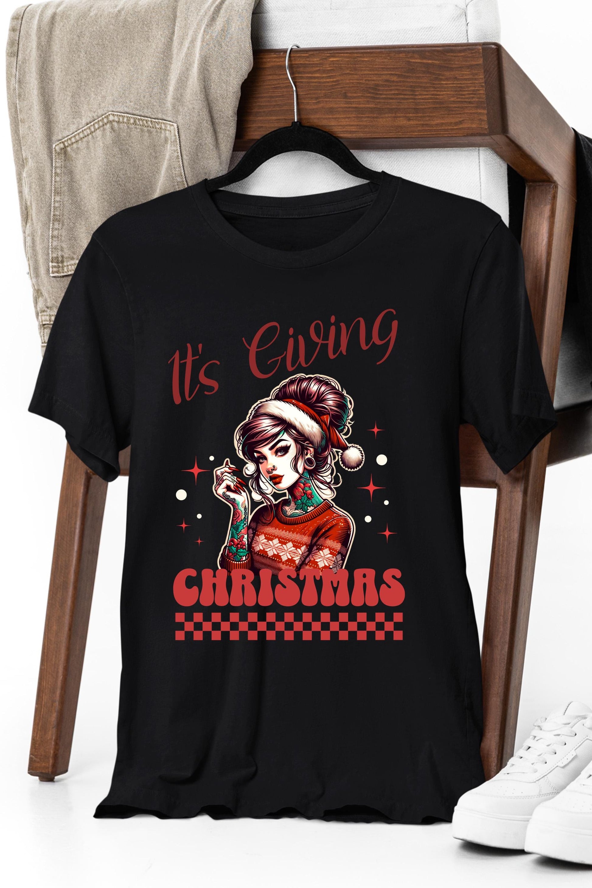 a black t - shirt with a picture of a girl wearing a santa claus hat