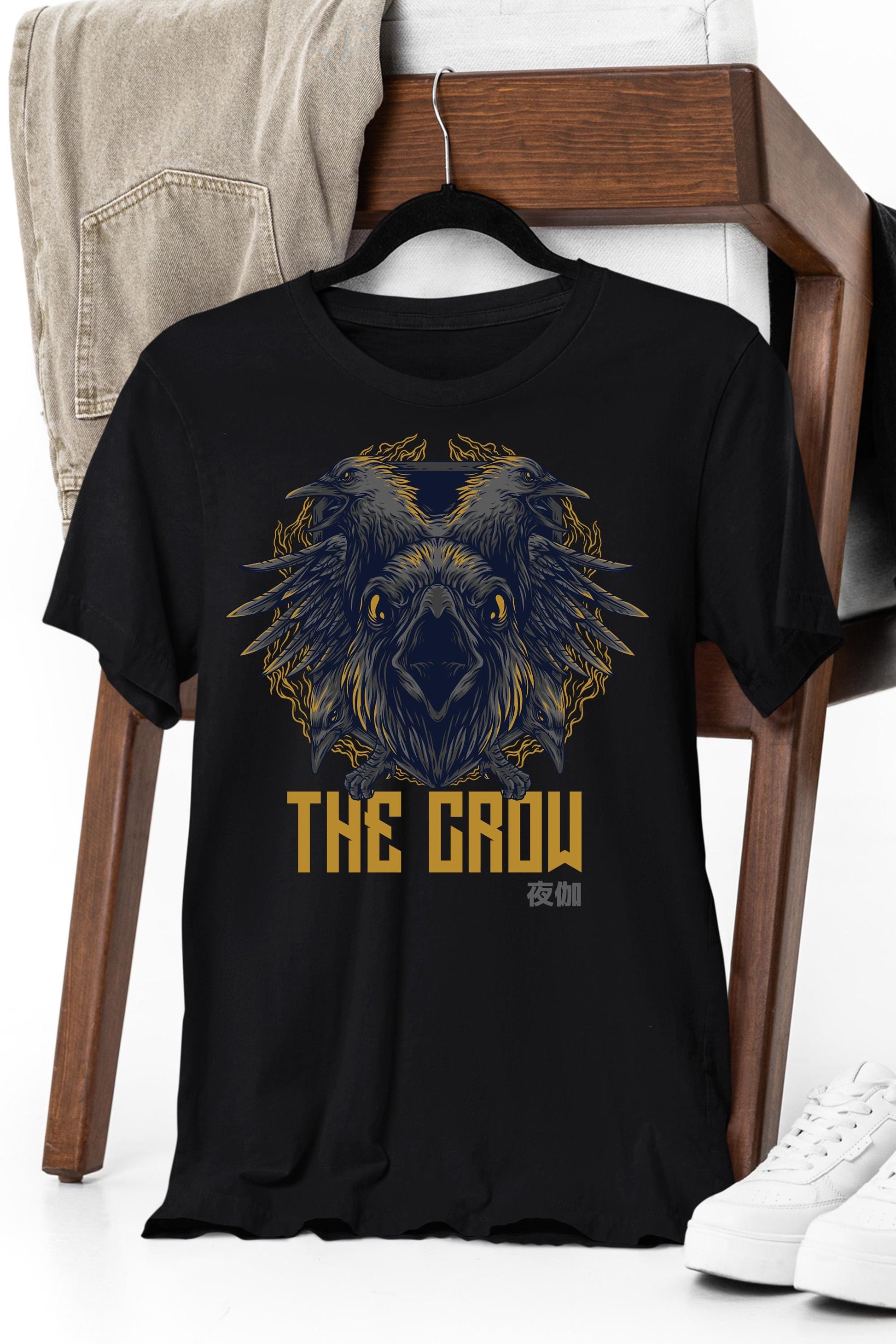 a black t - shirt with a picture of an owl on it